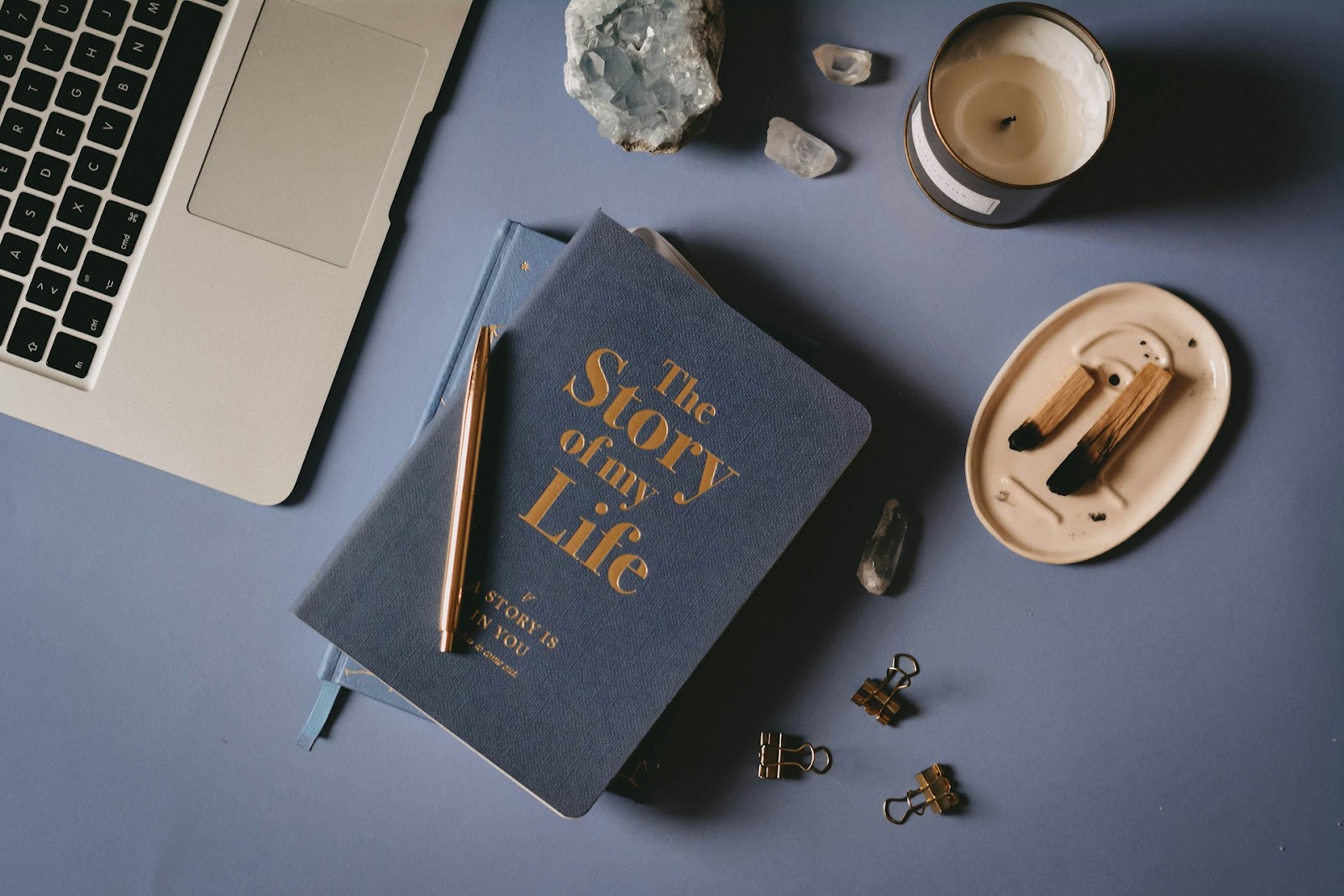 A journal, pen, and laptop computer. 