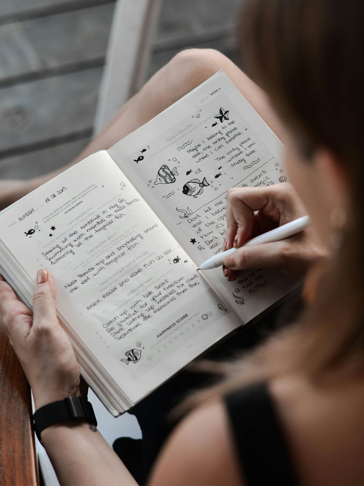 A woman writing in her journal. 