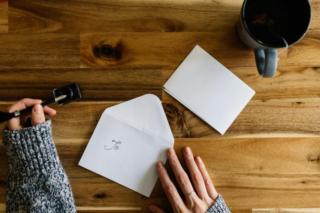 How to End a Letter A Woman Writing a Name on an Envelope