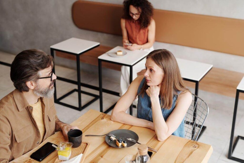 A man and a woman are talking in a restaurant