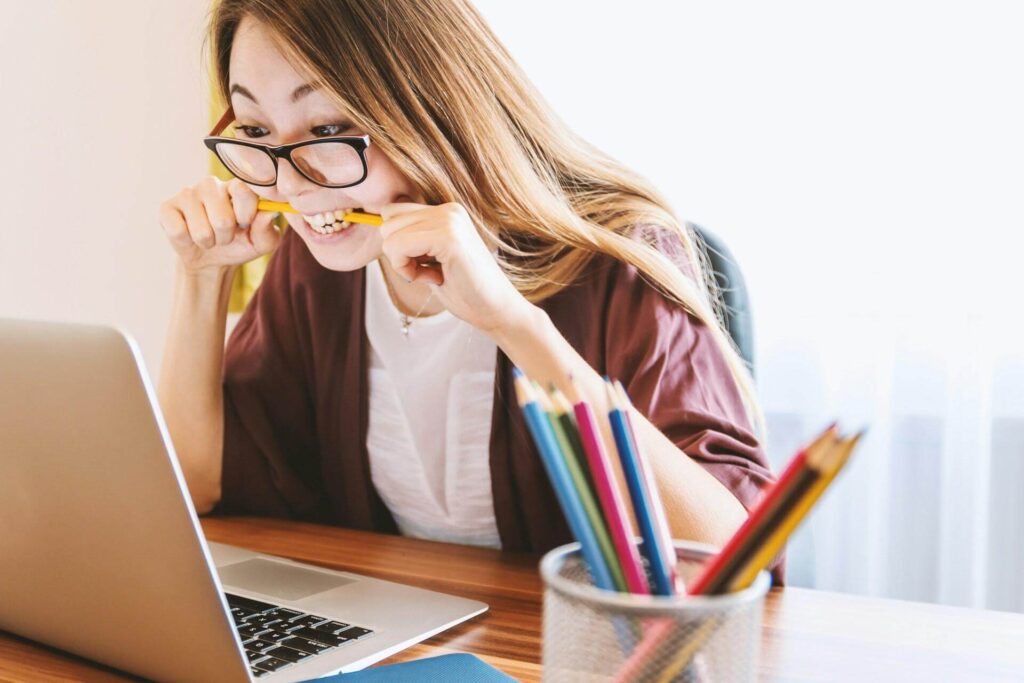 A student working on an essay on her laptop