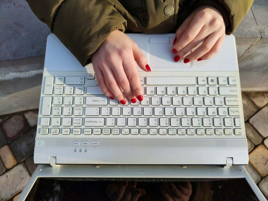 A woman typing on a computer