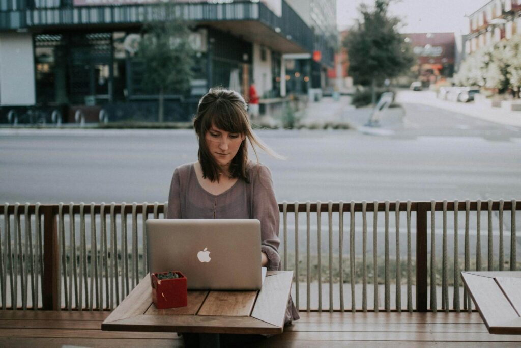 A woman working on an essay at a coffee shop