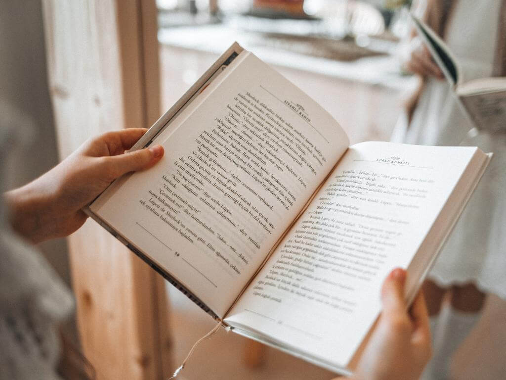 Two hands holding a book