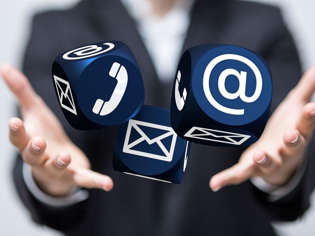 A man highlighting three icons: an envelope for email, a phone for call, and the "@" symbol.