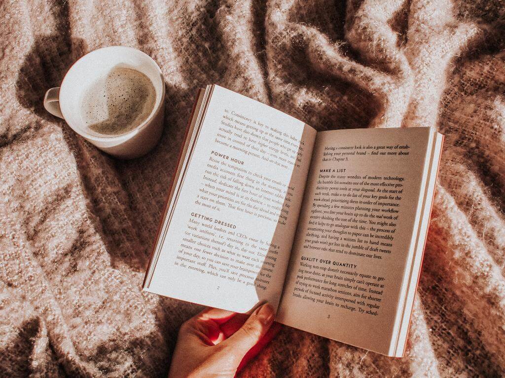 a book and a cup of coffee