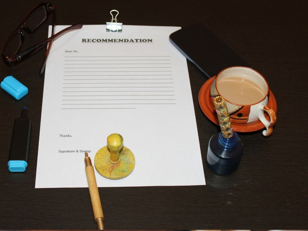 How To Write A Letter Of Recommendation. A recommendation letter placed with a cup of tea.