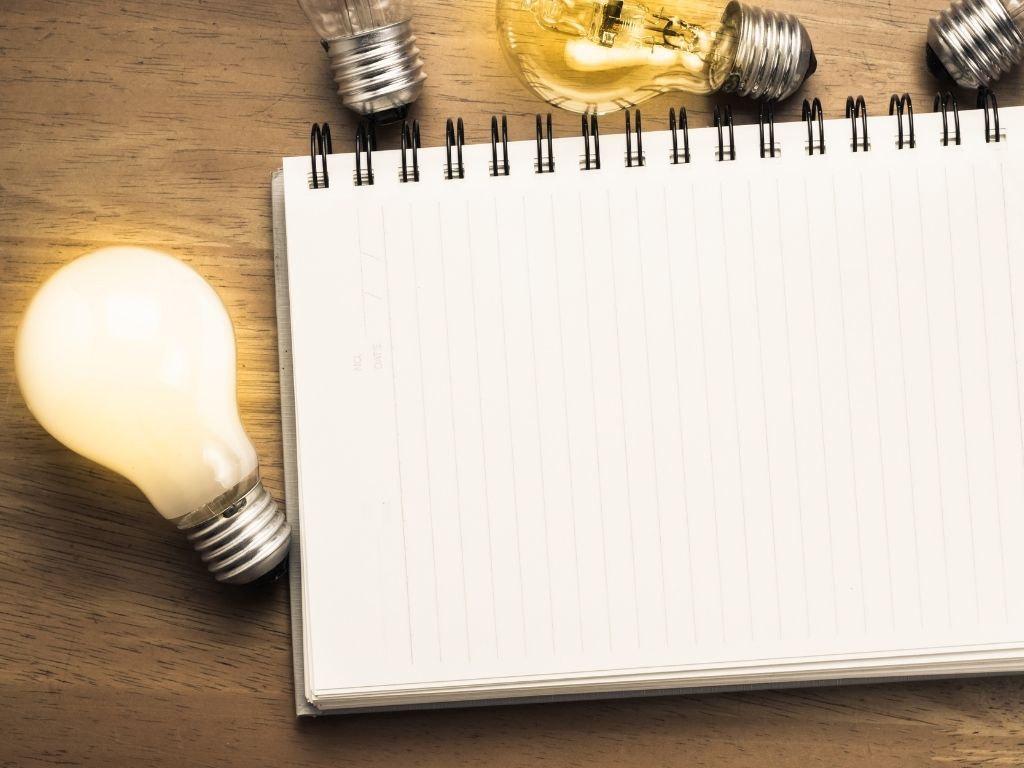 a notebook placed near a bulb