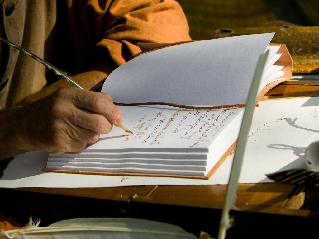 a person writing on a book