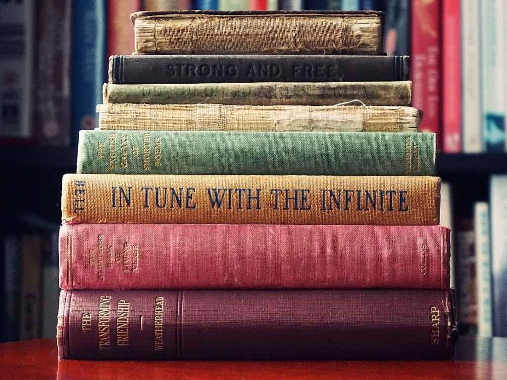 several books piled up on a table