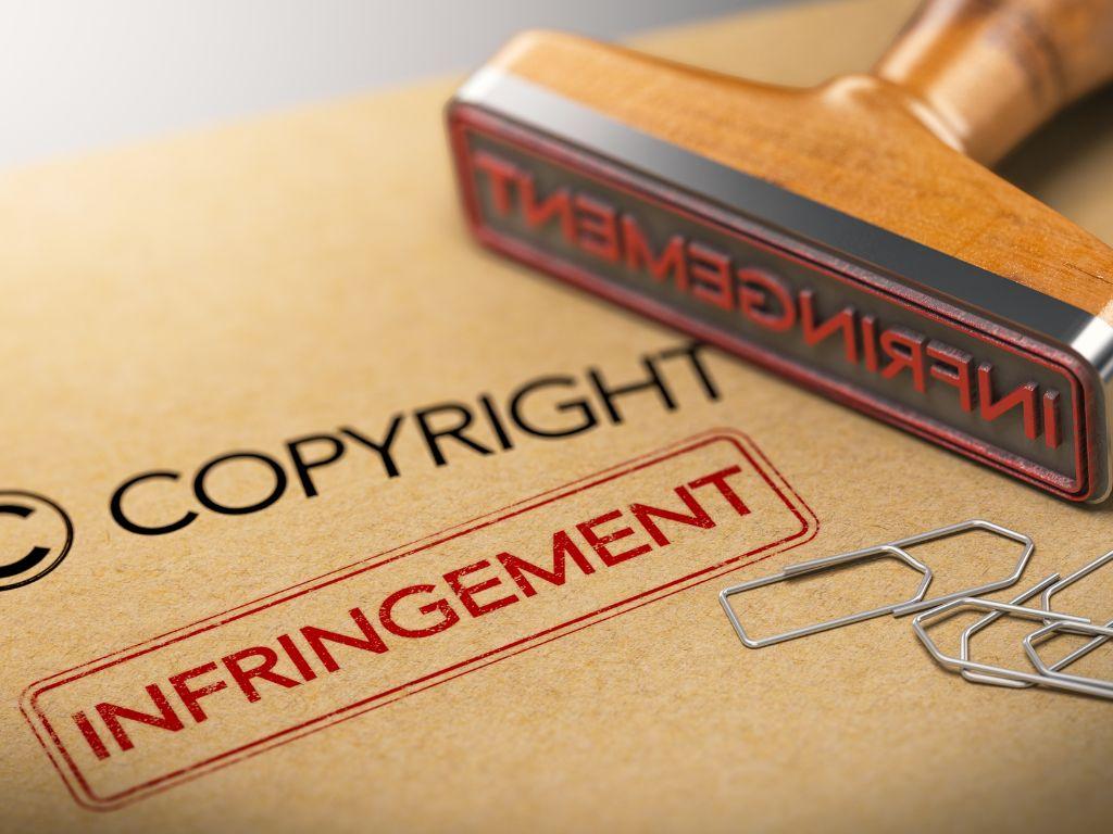 A copyright document placed on a table with an infringement stamp placed nearby