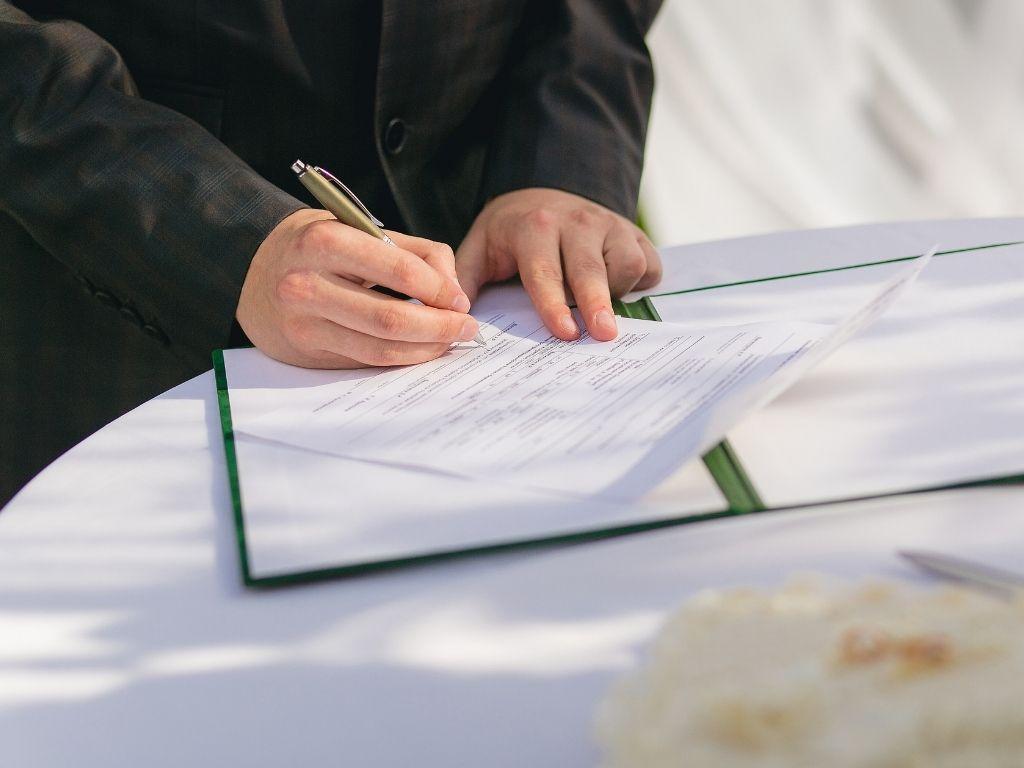 A man organizing and filling his documents on a table.