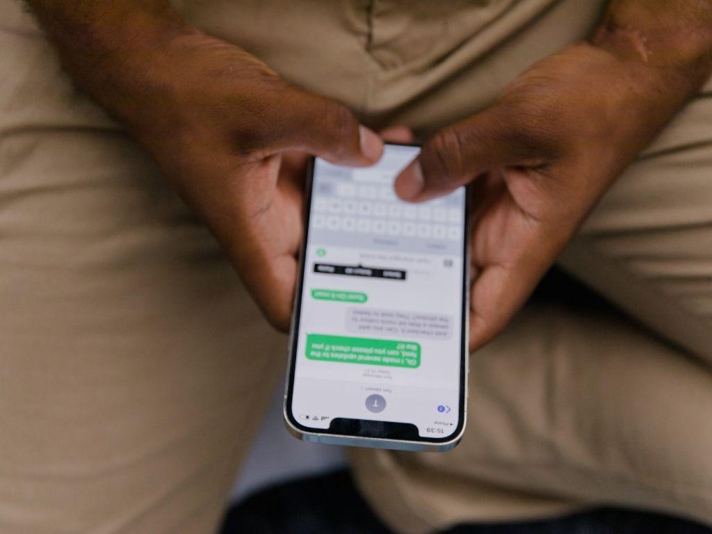 a man texting to someone on his phone