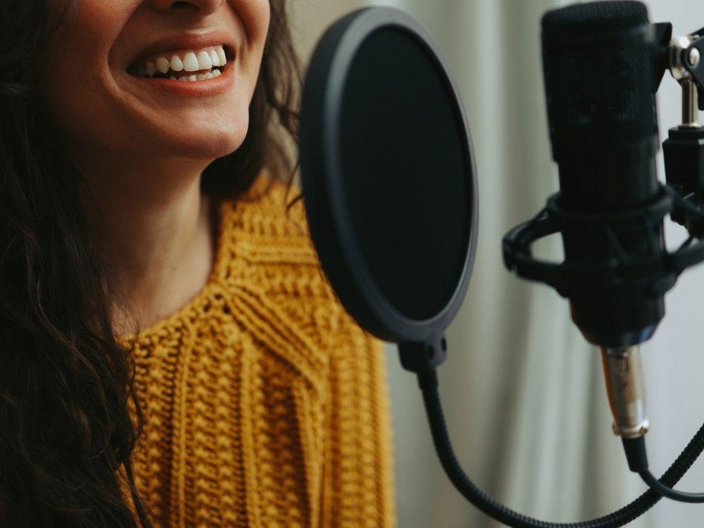 a girl standing in front of a microphone