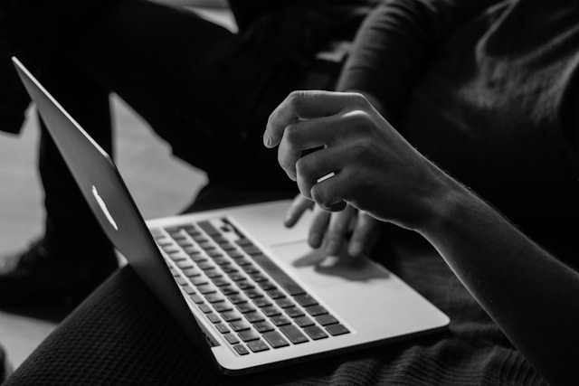 A student using a laptop in grey scale