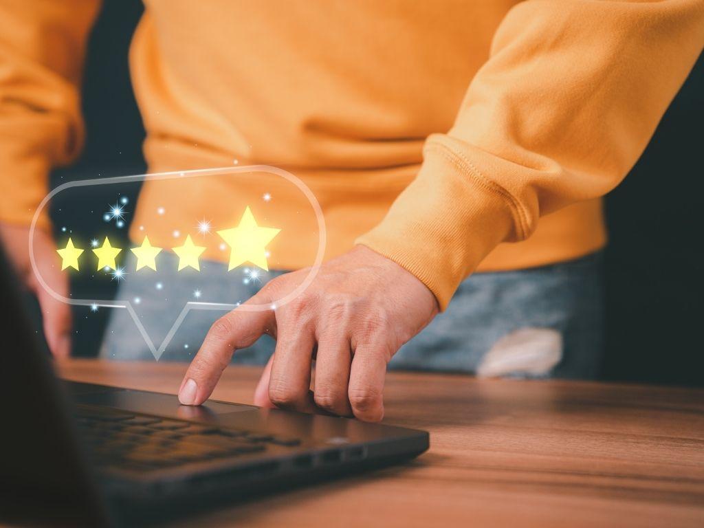 A man working on a laptop with 5 stars highlighted on the image