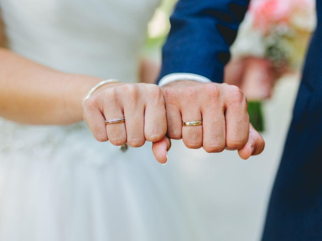 a couple showing their wedding rings