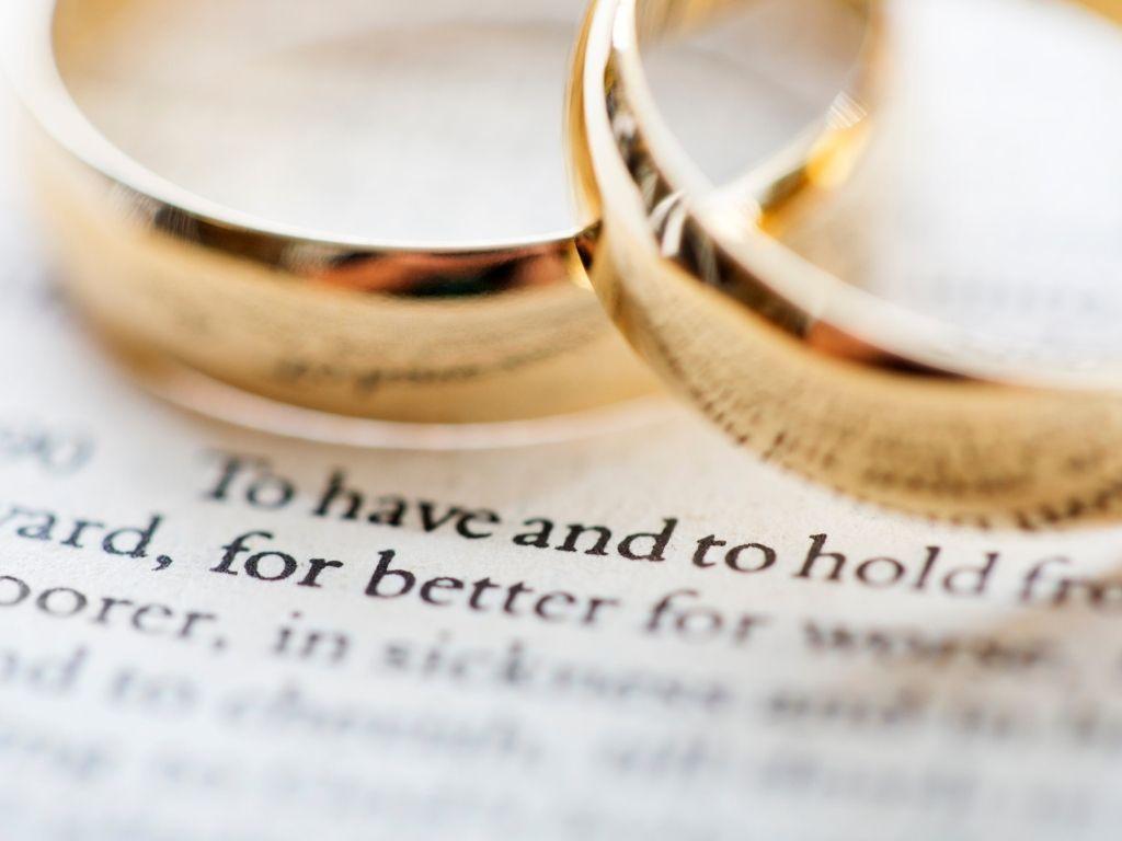 two wedding rings placed on a note 