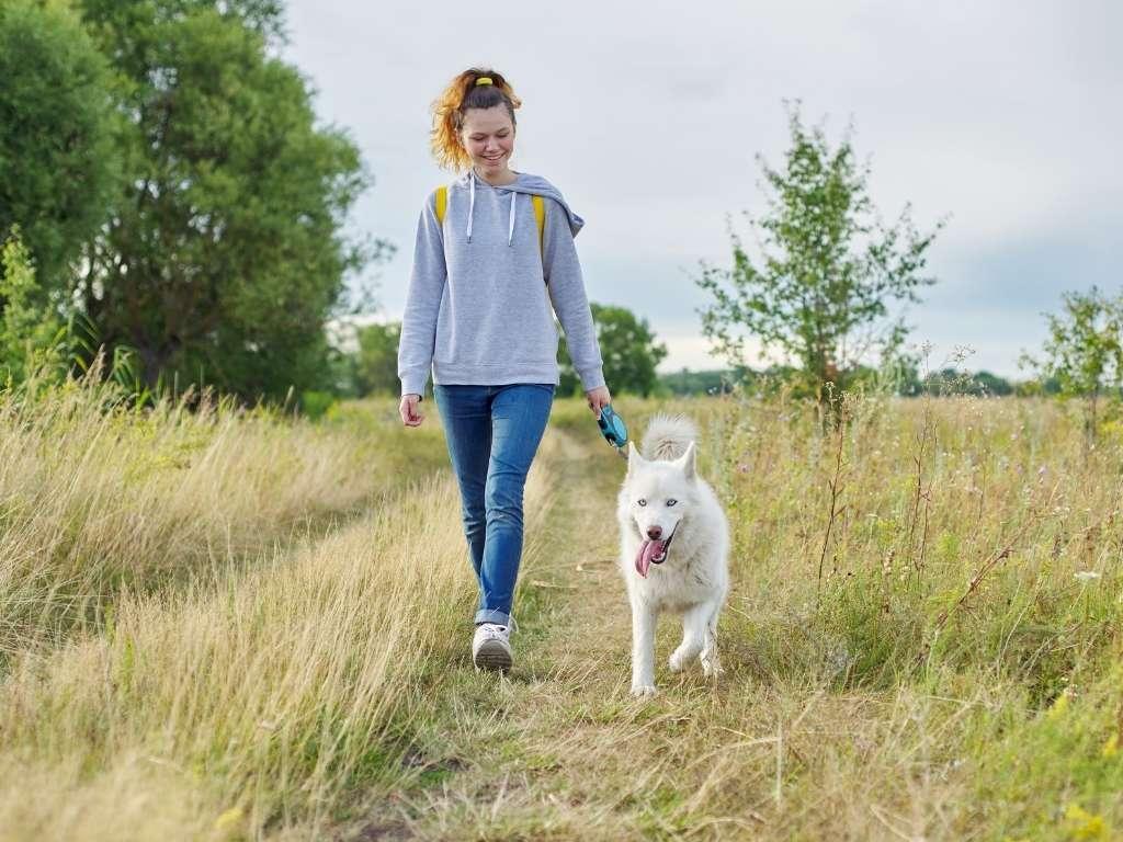 a girl walking her dog 