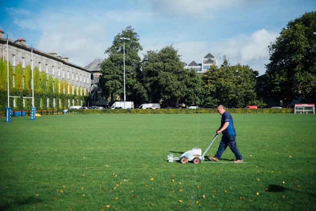 A business man mowing the lawn of a client