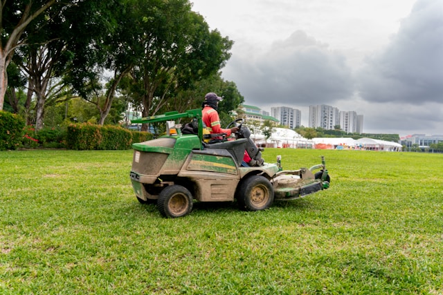 A landscape business owner mowing a client's grass 