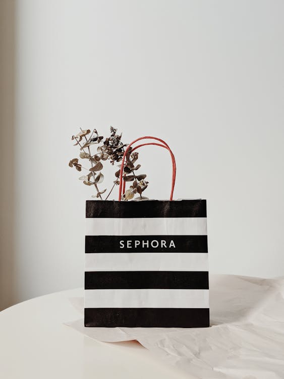 Free Stylish SEPHORA shopping bag with dried eucalyptus, perfect for minimalistic decor. Stock Photo